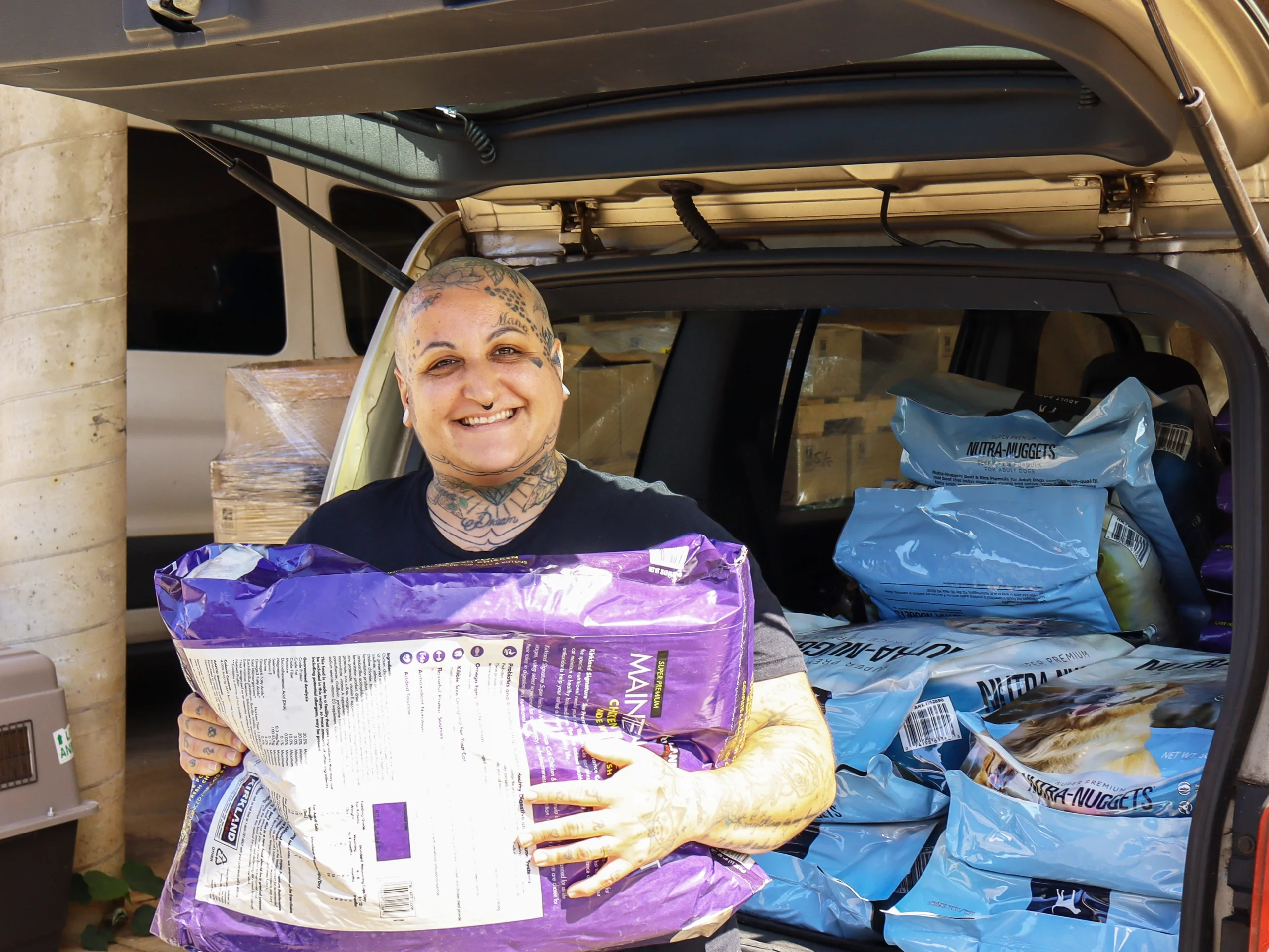 Volunteer Coordinator loading food for pet food bank kauai humane society